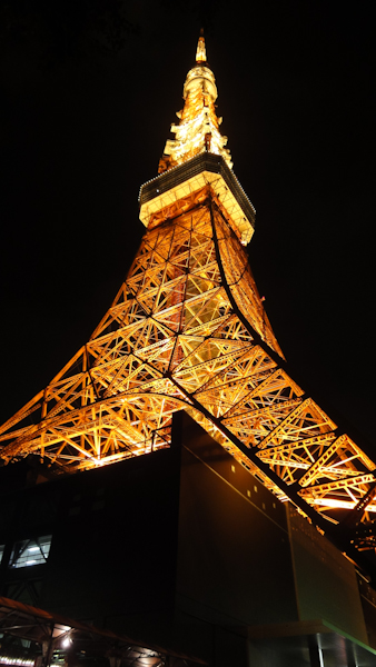 tokyo tower lit vermillion orange at night